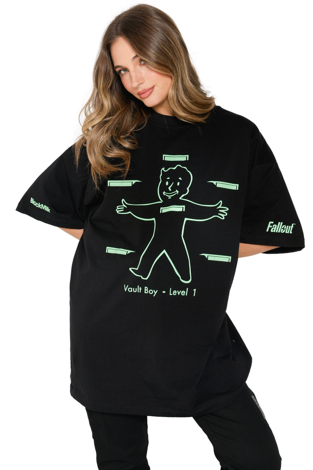 Fallout x BlackMilk glow-print t-shirt featuring Vault Boy body outline and “Vault Boy – Level 1” text.