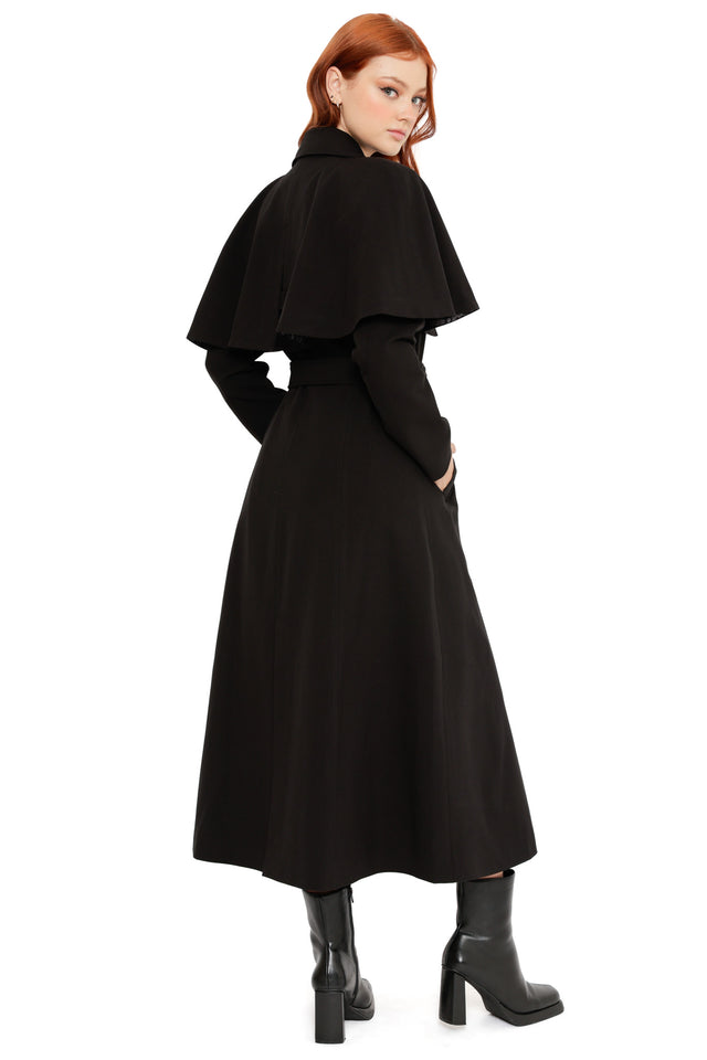 Model wearing the Heathcliff 3 in 1 Trench Coat from the Wuthering Heights collection, featuring a gothic black trench design with lace lining and layered styling