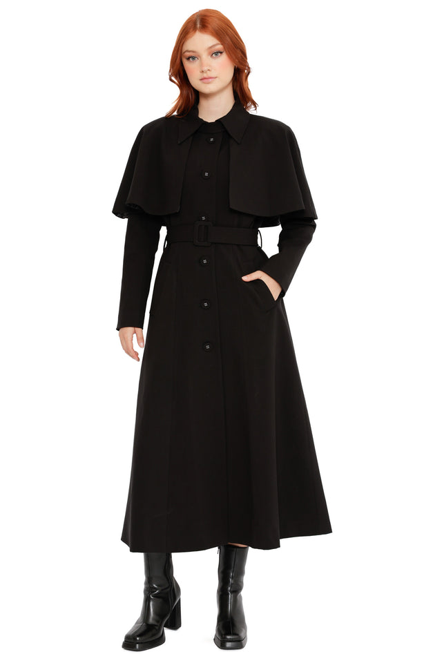 Model styled in the Heathcliff Trench Coat from the Wuthering Heights collection, showcasing a gothic black trench with lace lining, dramatic drape and removable layered design