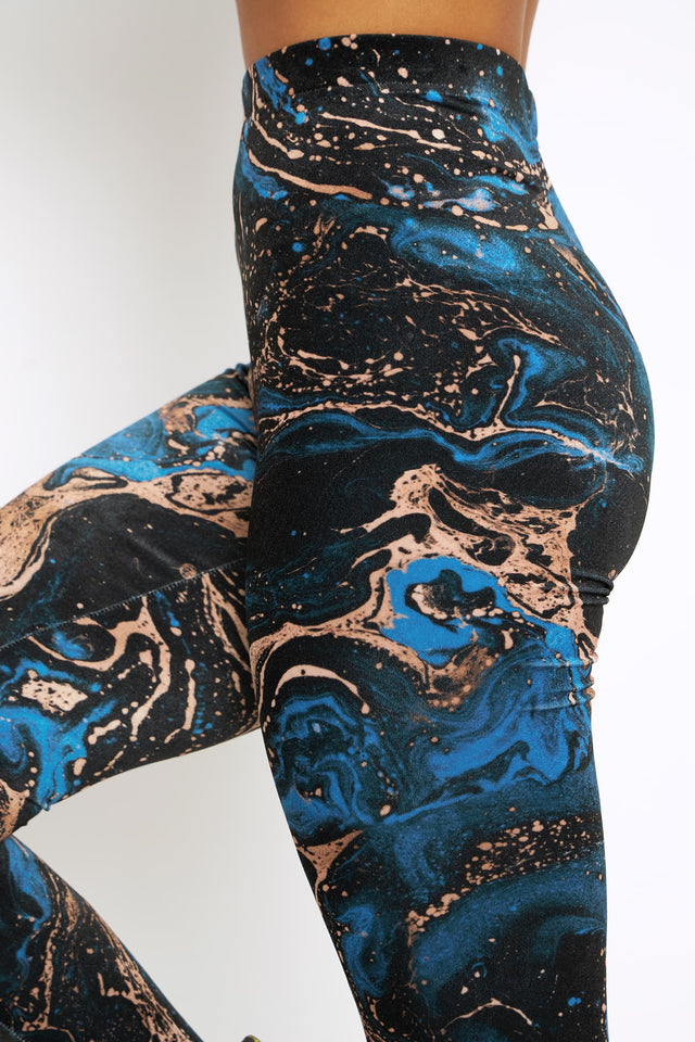 Model wearing I Bleed Minerals Velvet High Waisted Leggings by BlackMilk Clothing, abstract blue and copper mineral print velvet leggings with high waist