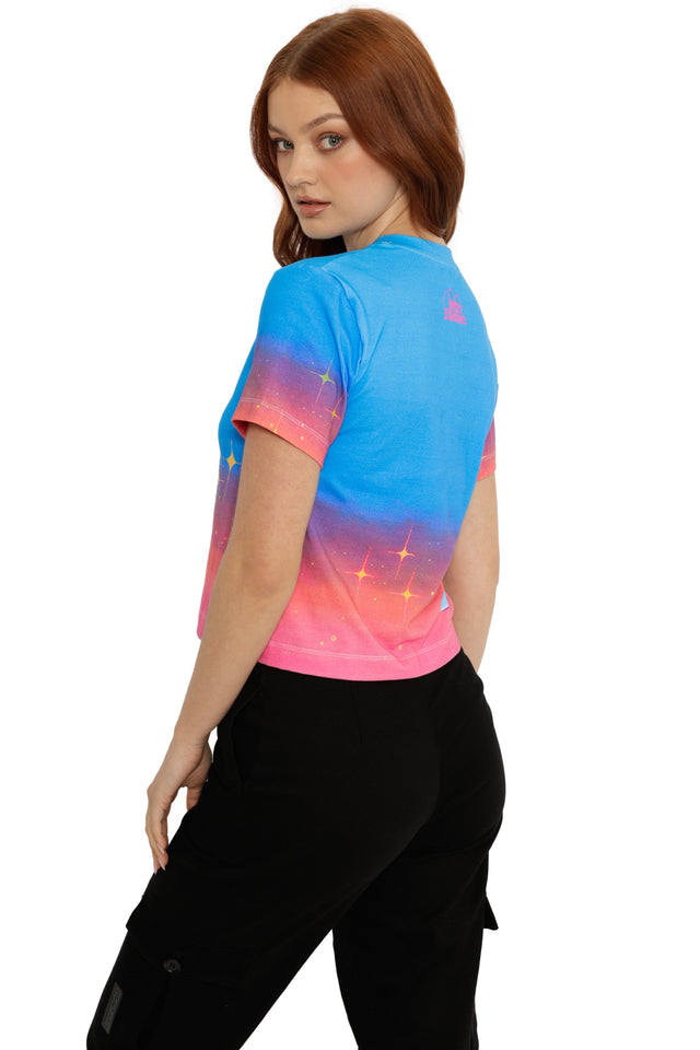 Woman wearing a colorful gradient t-shirt with black pants on a white background