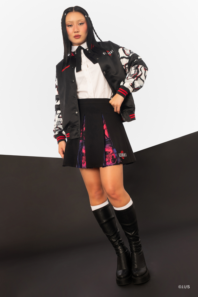 Junji Ito x BlackMilk Uzumaki pleated mini skirt in black with zip front closure, hidden magenta and violet spiral manga panels, Japanese horror anime streetwear for women.