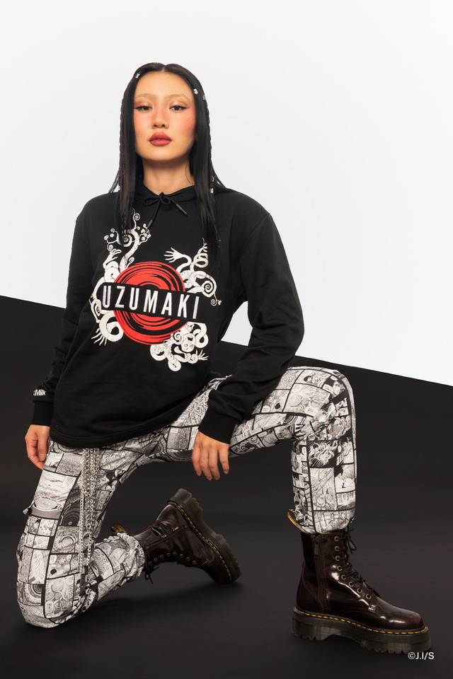 Junji Ito x BlackMilk Twisted Within hoodie sweater in black cotton French terry, featuring a bold red Uzumaki spiral graphic at the centre with manga inspired artwork in a relaxed unisex fit.