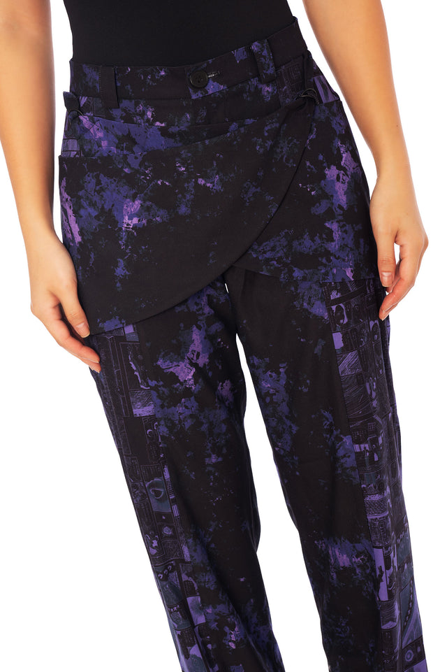 Harajuku-inspired Junji Ito Uzumaki pants featuring layered asymmetric front panels and deep black and violet manga artwork.