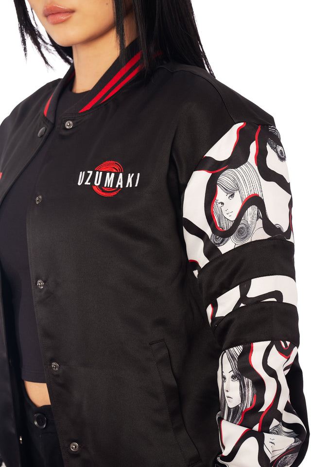 Black satin Uzumaki varsity jacket with red spiral curse illustration on the back, Japanese manga streetwear outerwear from Junji Ito x BlackMilk.