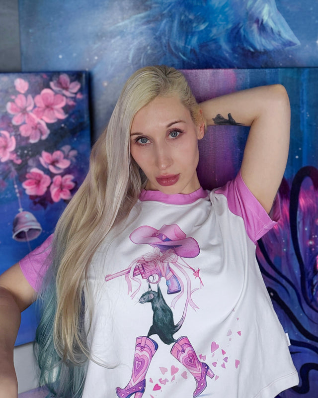 Illustrated baby tee from the Lora Zombie collection with pink sleeves, crew neckline, and playful character design.