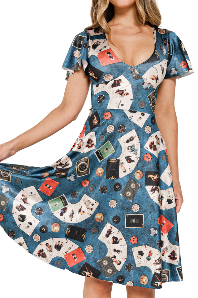 Model in Fallout x BlackMilk Lucky Gal Flouncy Midi Dress printed with cards, Nuka-Cola labels and Fallout motifs. Detail view