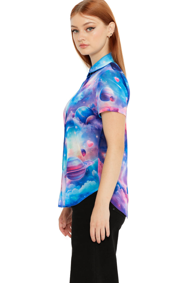 Front view of a pastel space-themed button-up top with clouds, planets and soft cosmic colours.