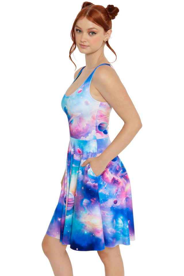 Space-inspired skater dress in pink, blue and purple tones with planet motifs and a soft, dreamy galaxy print