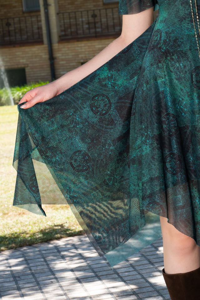 Front full length image of Moss Maiden Handkerchief Short Sleeve Dress with deep green tonal print, fitted bodice and layered handkerchief hem detail