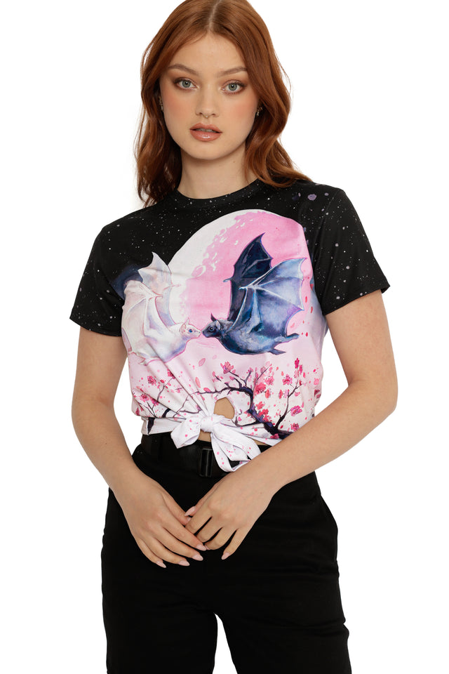 Woman wearing a black t-shirt with a colorful butterfly design on a white background