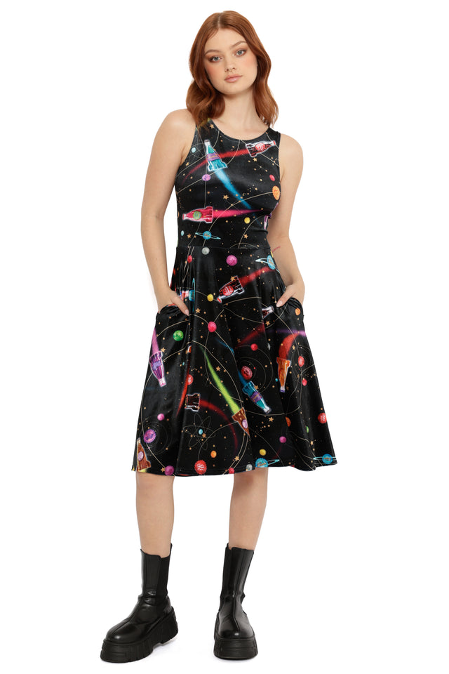 Model wearing Fallout x BlackMilk Nuka-Space Velvet Dress with colourful planets and rocket ship design.