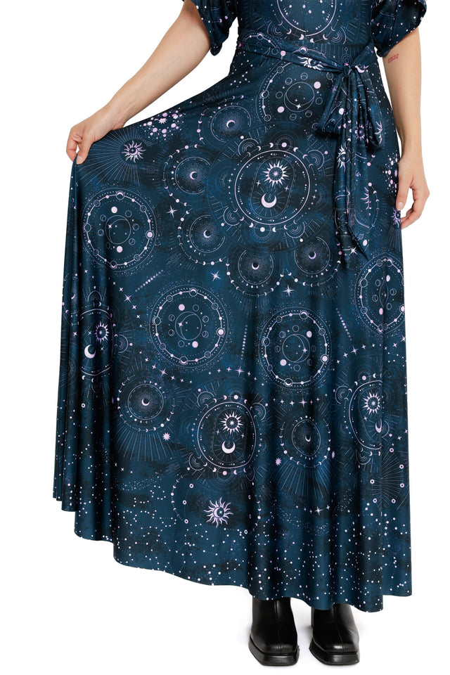 Navy short-sleeve wrap dress with tie waist and all-over cosmic symbols including suns, moons and star maps.