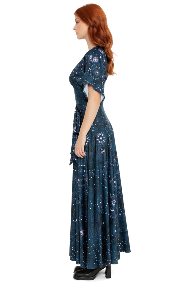 Celestial-inspired navy maxi dress featuring circular star charts, crescent moons and scattered starlight details.