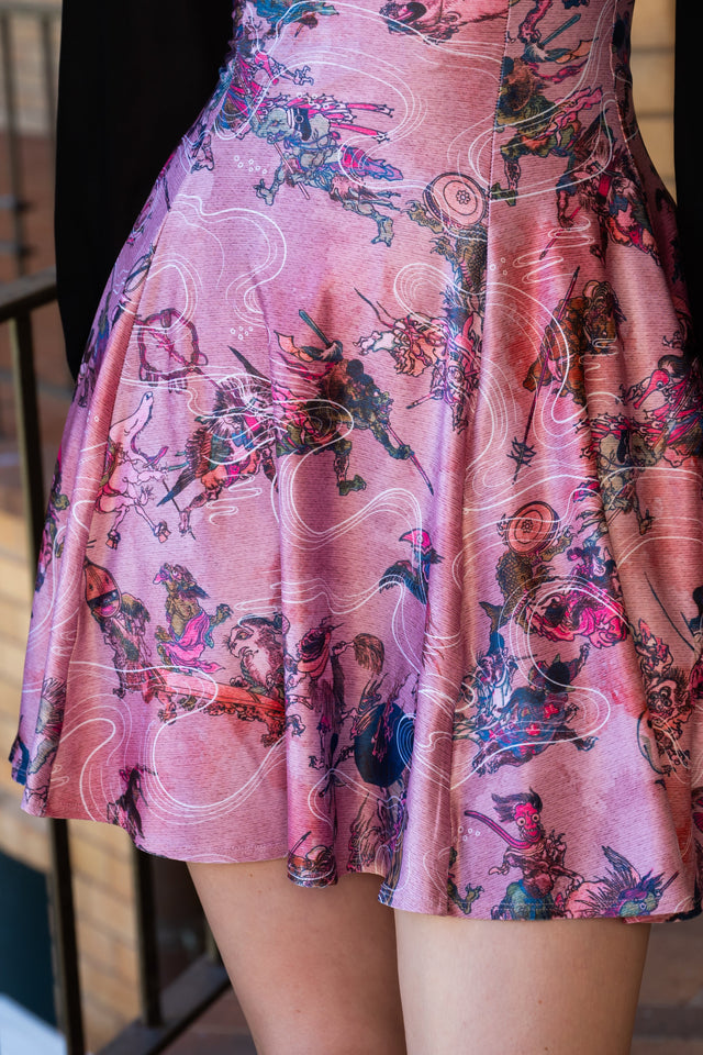 Pink One Hundred Demons Mini Strappy Dress with Japanese yokai inspired print, fine shoulder straps, fitted bodice and flared mini skirt silhouette