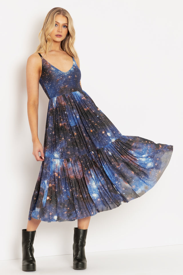 sheer galaxy dress An embodiment of celestial elegance, this galaxy organza frock features a refined jewel neckline, delicately framed with scalloped detailing along the upper bodice to create a graceful sheer effect at both the