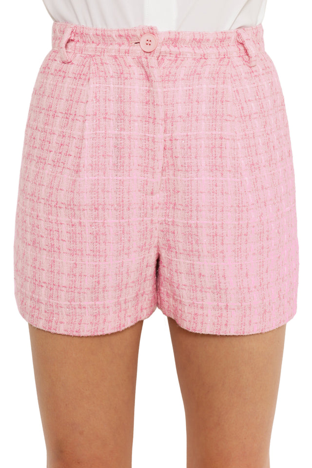 Pink checkered shorts worn by a person on a white background