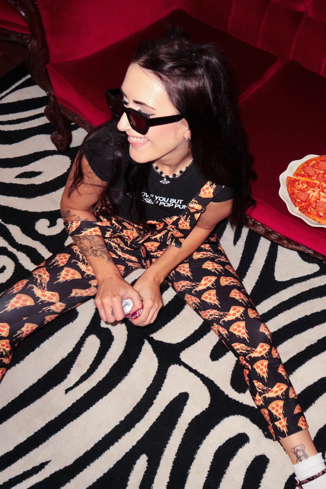 Side view of BlackMilk pizza overalls highlighting fitted legs, smooth fabric drape and adjustable strap construction