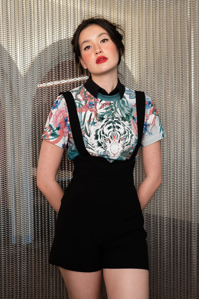 Women’s fitted baby tee featuring white tiger artwork, pastel floral print, crew neckline and cropped short sleeve silhouette