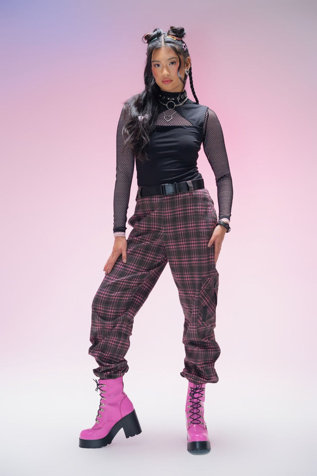 Pink tartan cargo pants featuring oversized utility pockets, a removable belt, elastic cuffed ankles and a relaxed streetwear silhouette crafted from durable cotton-rich fabric.