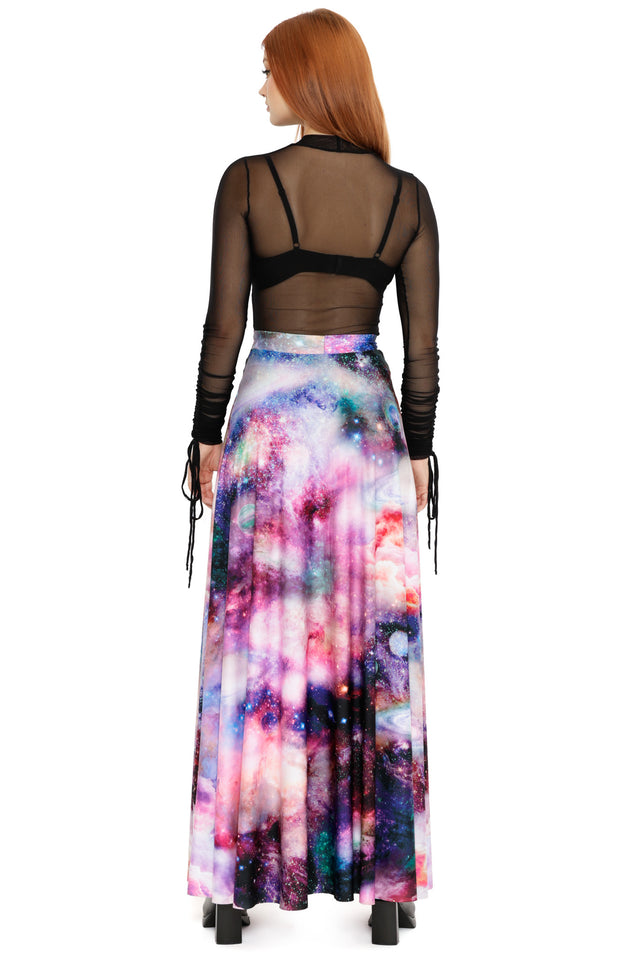 Ethereal space-inspired outfit featuring a sheer black top and a dramatic flowing galaxy print maxi skirt