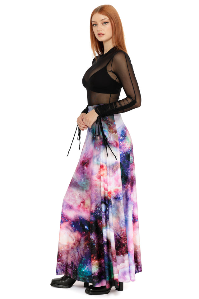 Galaxy print maxi skirt in pink, purple and blue hues worn with a fitted sheer black mesh long sleeve top