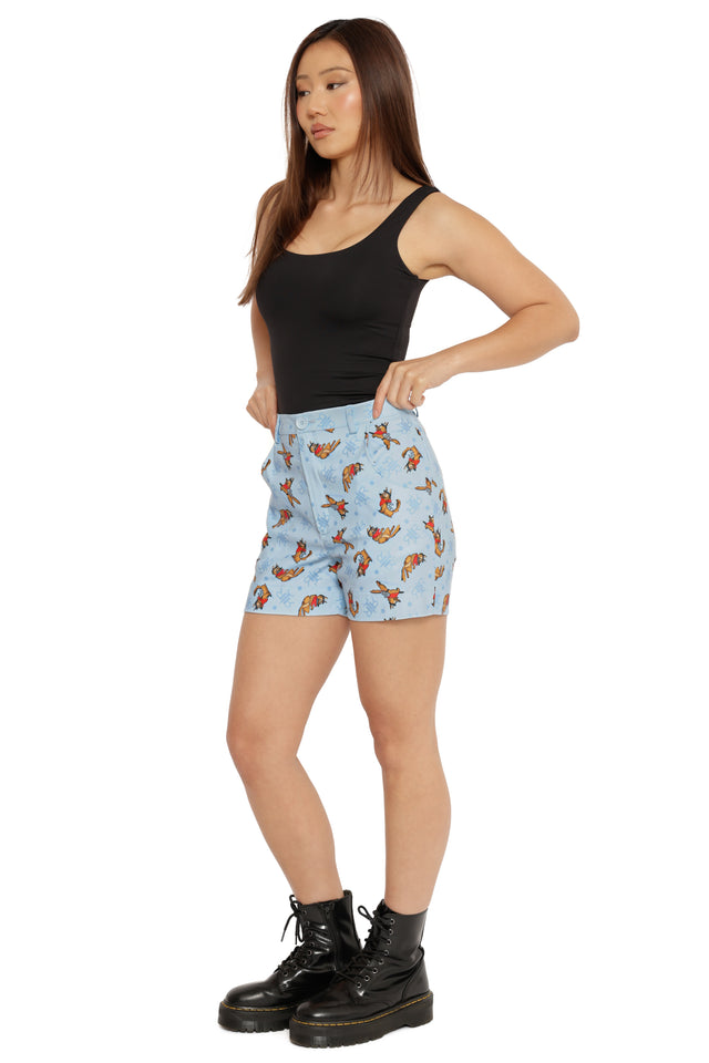 Close-up of Fallout x BlackMilk Red Rocket Station Shorts featuring playful Dogmeat artwork on blue background.