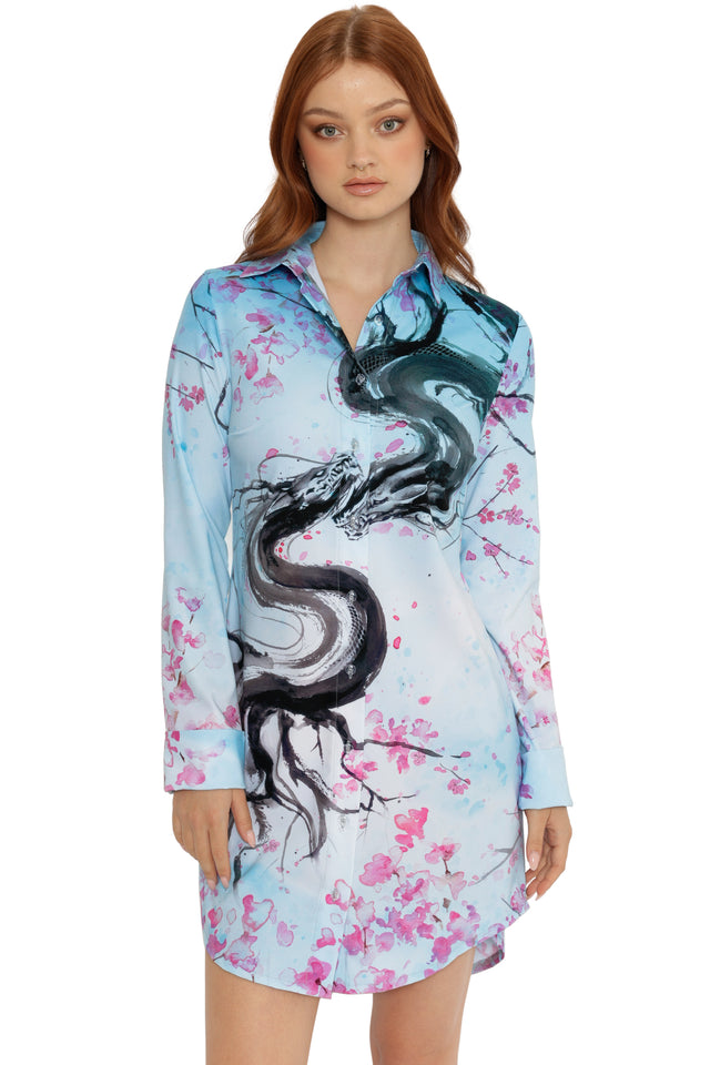 Woman wearing a dress with dragon and floral design on a white background