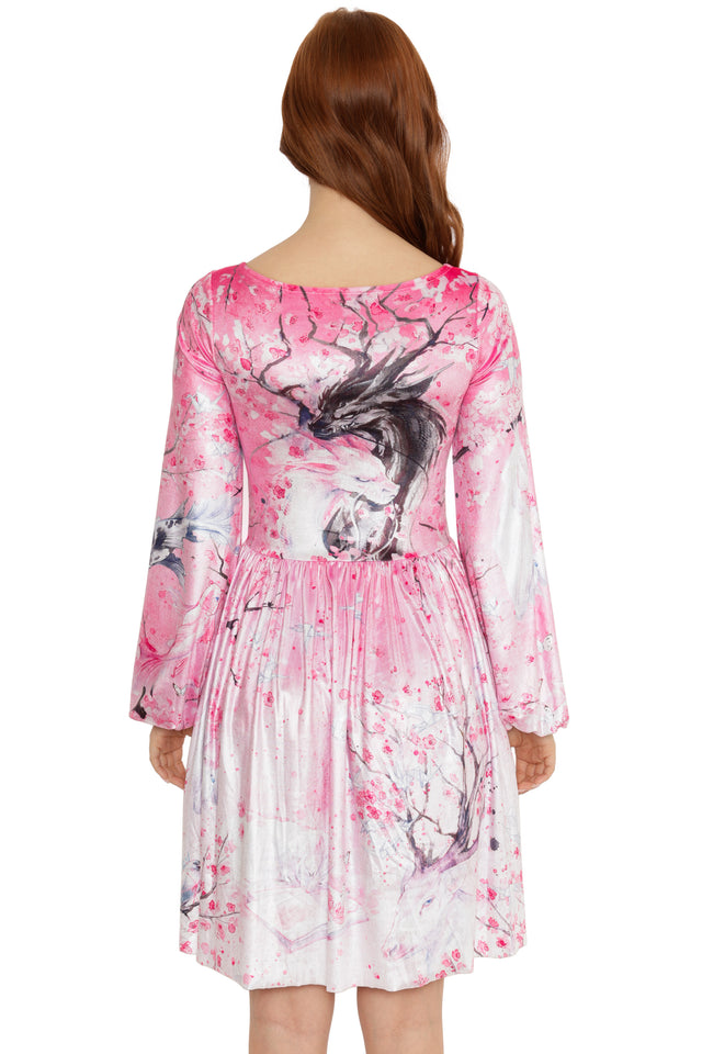 Woman wearing a pink dress with deer and floral design on a white background
