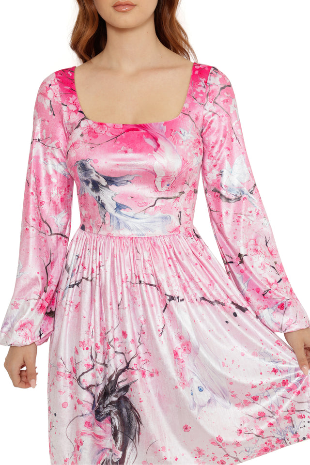 Pink dress with abstract designs on a white background