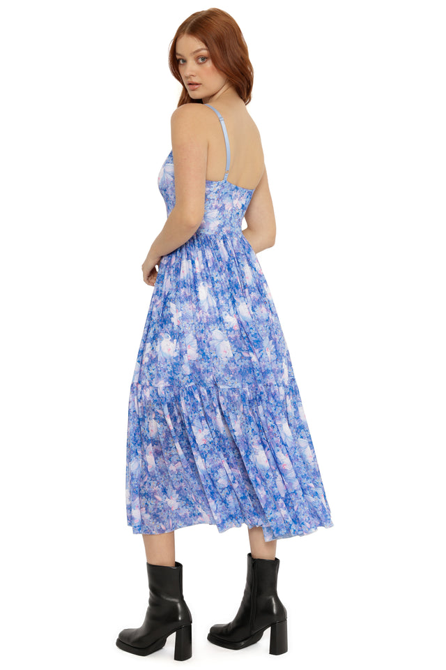 Woman wearing a blue floral dress on a white background