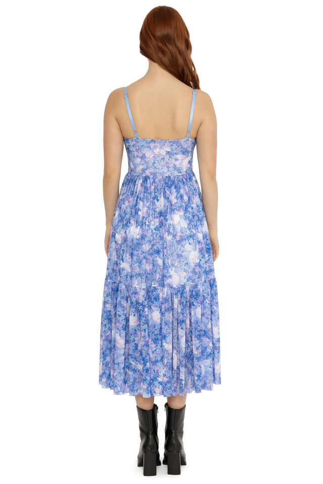 Woman wearing a blue floral dress on a white background