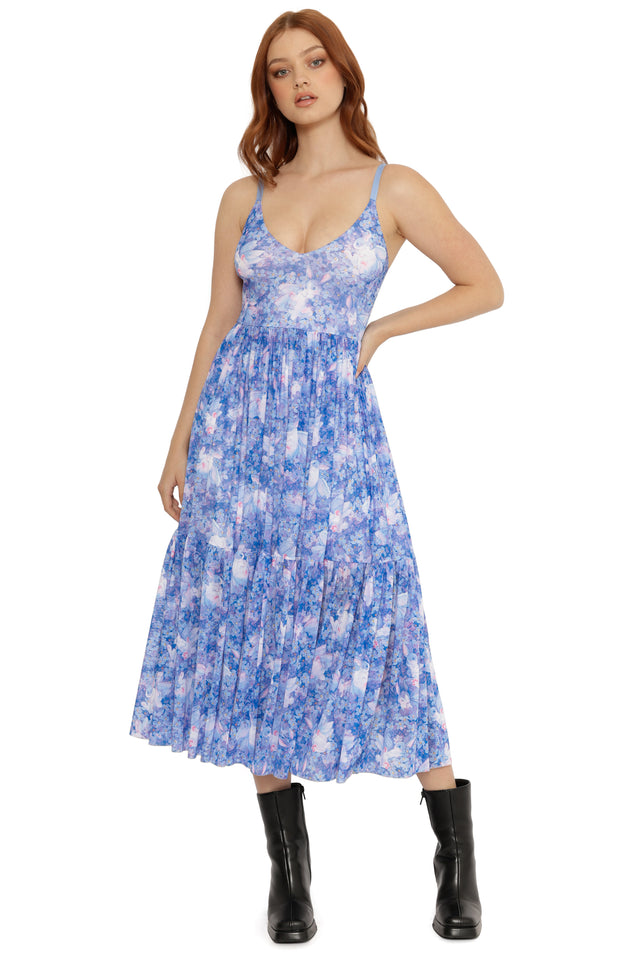Woman wearing a blue floral dress on a white background