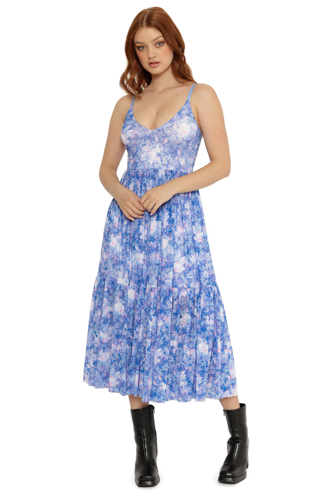Woman wearing a blue floral dress on a white background
