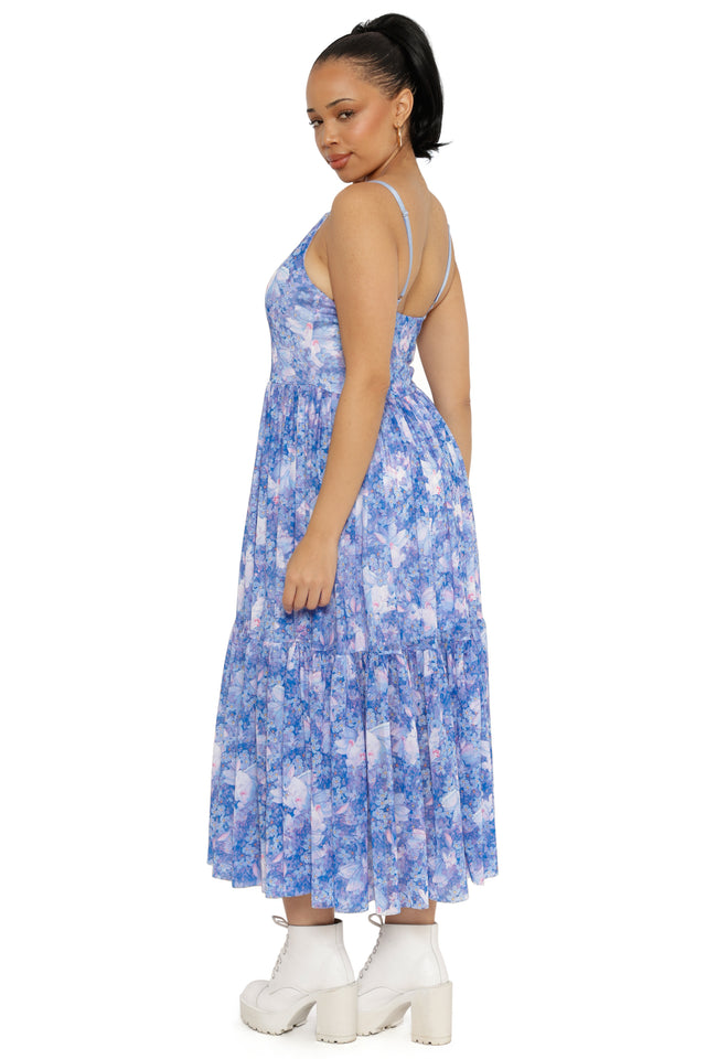 Woman wearing a blue floral dress on a white background