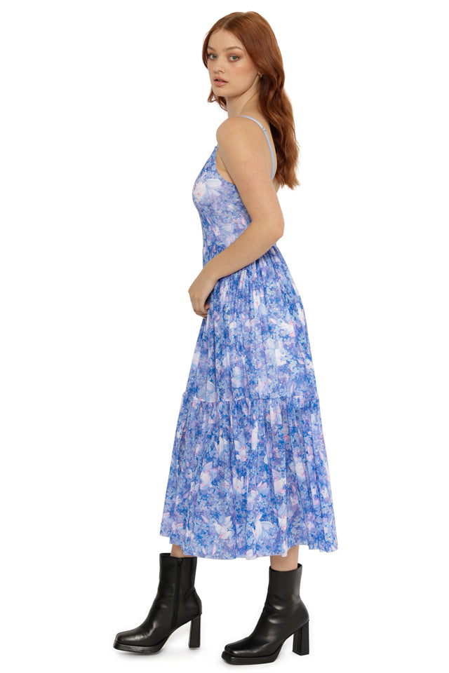 Woman wearing a blue floral dress on a white background