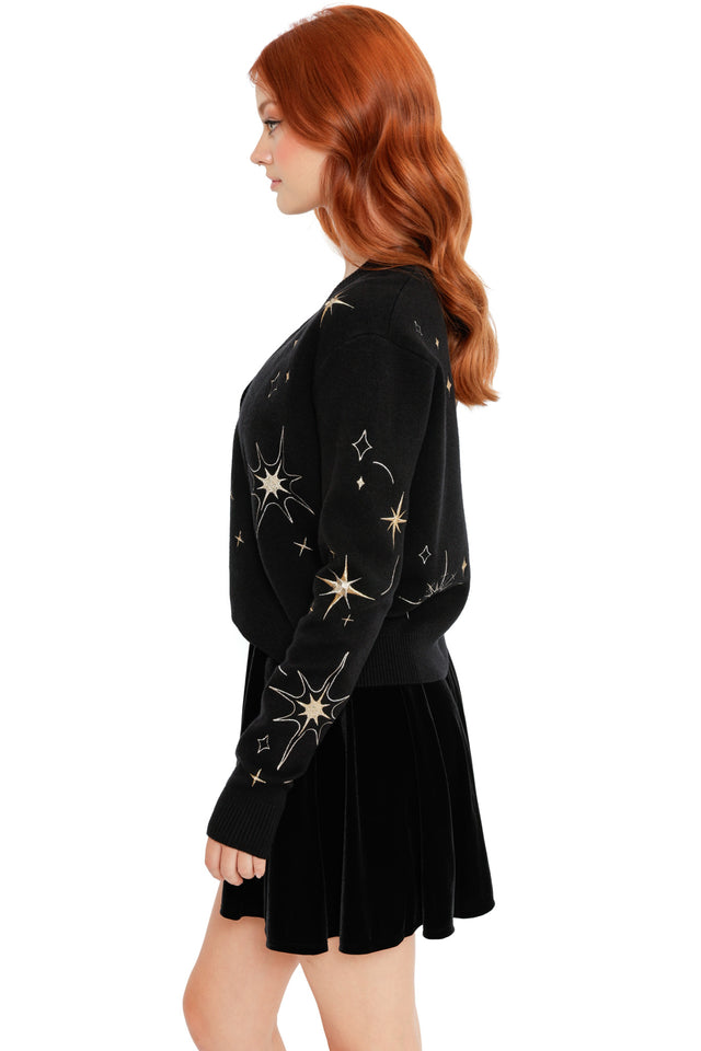 Space-themed black cardigan with gold celestial motifs, ribbed cuffs and a lightweight knit feel