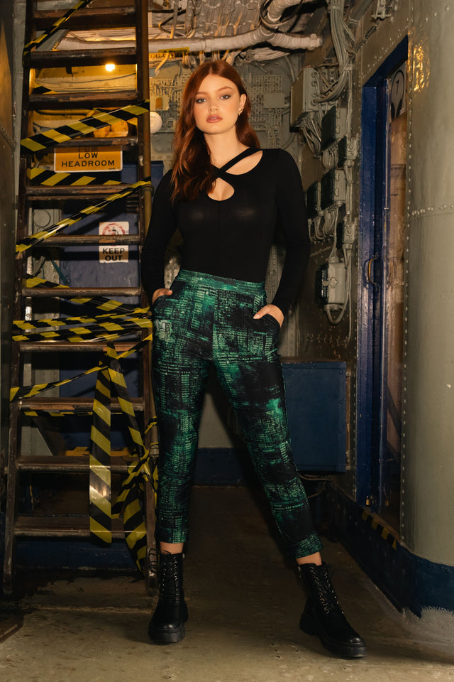 Model wearing Fallout x BlackMilk Termlink Hacking Cuffed Pants featuring green terminal code print and relaxed tapered fit.