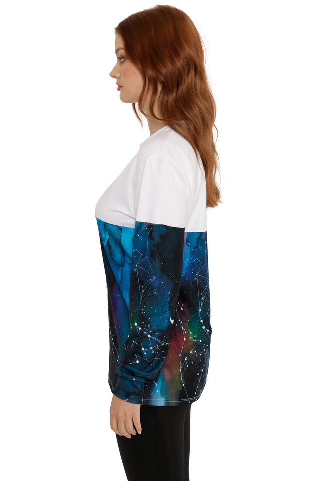 Woman wearing a white and blue galaxy-themed shirt on a white background