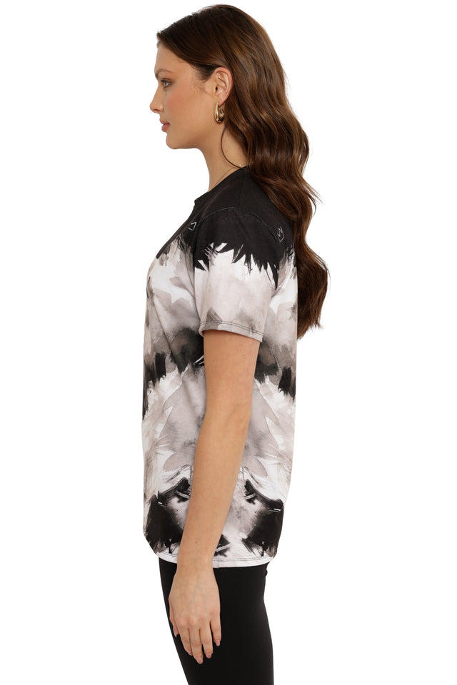 Woman wearing a black and white patterned shirt on a white background