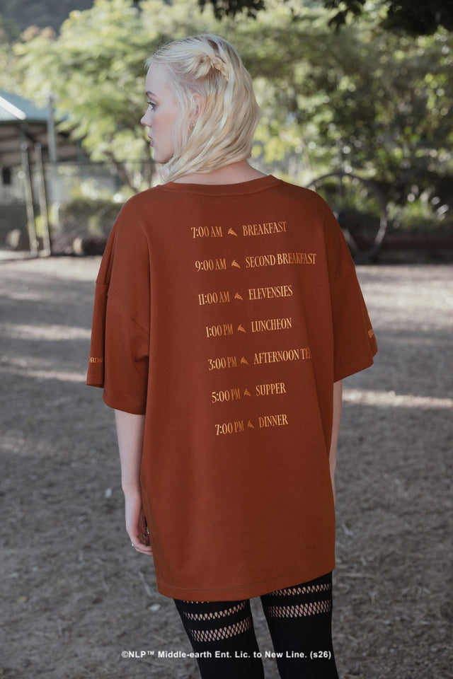 Close-up campaign shot of the What About Elevenses? Big Tee by BlackMilk, showing The Green Dragon graphic print inspired by hobbit second breakfast culture.