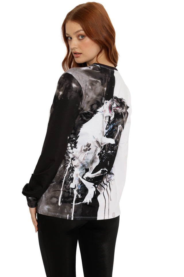 Woman wearing a black and white graphic long-sleeve shirt with a horse design on a white background