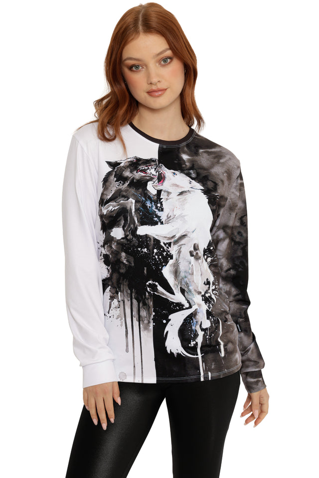 Woman wearing a long-sleeve shirt with a black and white wolf design on a white background