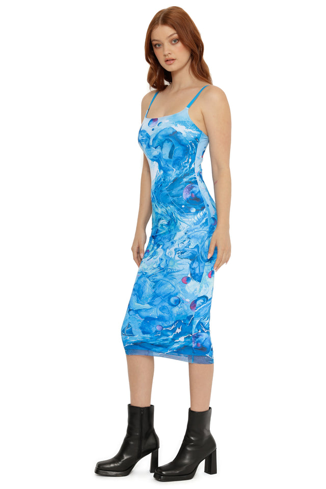 Woman wearing a blue floral dress on a white background