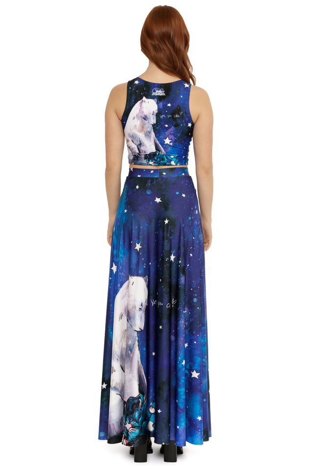 Woman wearing a blue dress with polar bear and star design on a white background