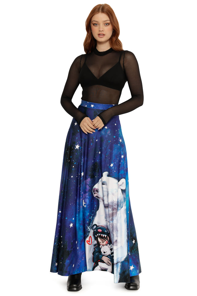 Woman wearing a blue skirt with a polar bear and cartoon character print on a white background