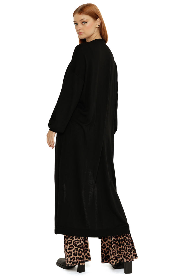 Black Super Cardigan in a longline maxi length, worn open with relaxed sleeves and a soft draped fit.