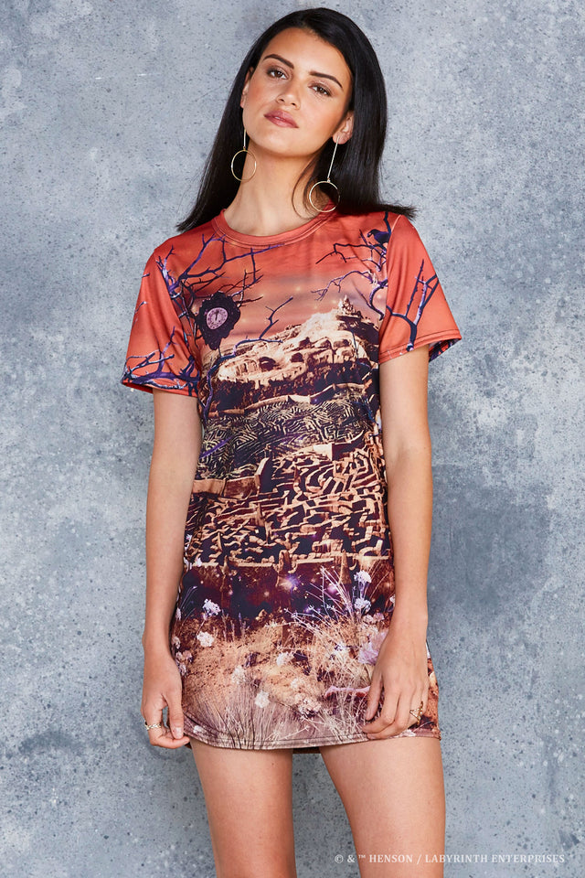 BlackMilk Labyrinth Turn Back Tee Dress - officially licensed Jim Henson's Labyrinth (1986) merch featuring an all-over print of the Goblin City maze and castle under a fiery sunset sky - front view of model.