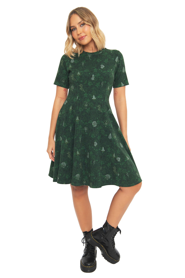 Close-up front view of the BlackMilk Bag End Wallpaper Longline Tee Dress, showing the intricate Bag End-inspired print detail in dark green cotton.