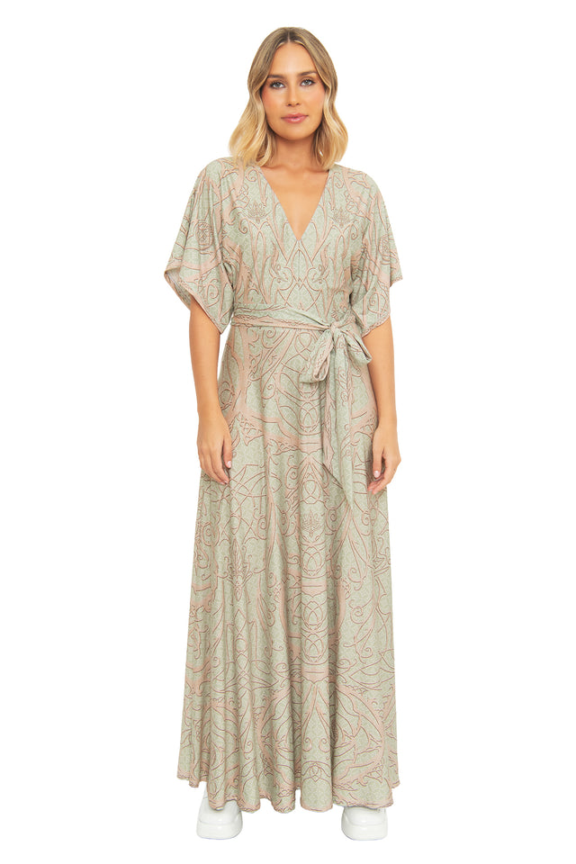 Front view of a model wearing the BlackMilk Elves of Middle-Earth Maxi Dress, a kimono-sleeve wrap-style gown with intricate Elvish filigree print in sage green, inspired by Legolas and the Elves of Middle-earth.